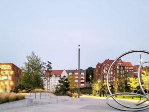 a sculpture in a park with buildings in the background at 4 person holiday home in Sønderborg in Sønderborg
