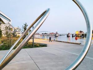 a silver metal railing with a bridge in the background at 4 person holiday home in Sønderborg in Sønderborg
