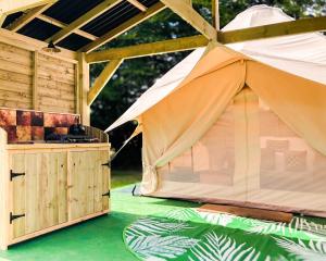 a large tent is set up on a green floor at Taylor the Burt in Penuwch