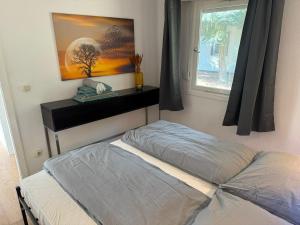 a bedroom with a bed and a window at Feriendorf Seddiner See - Bungalow 4 in Seddin