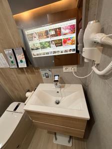 a bathroom with a sink and a toilet at Futurotel Granada Dreams in Granada