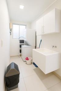 a white bathroom with a sink and a counter at Costa Rica, San José, Pinares Luxe Apt Near Elite Clinics in San José +14 photos