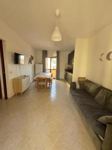 a living room with a couch and a table at Isola Rossa Appartamenti Comfort plus in Isola Rossa