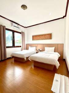 Katil atau katil-katil dalam bilik di 帕拉花园酒店 Pala garden hotel