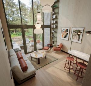 a living room with a couch and a table and chairs at Green View Tornow in Fürstenberg