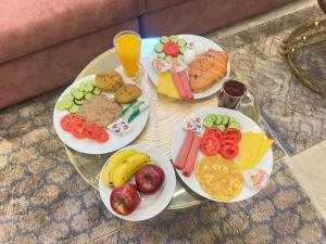 a glass table with plates of food on it at Cairo Crystal Hotel in Cairo