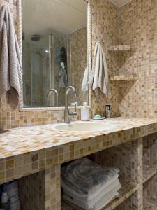 a bathroom with a sink and a mirror at חופשה חלומית in Caesarea +13 photos