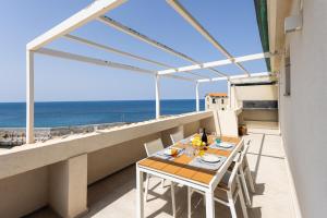 a balcony with a table and a view of the ocean at AUREA collection SEA VIEW in Cefalù