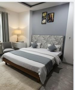 a bedroom with a large bed and a chair at Hotel Season Couple friendly Rooms Best Hotel Pitampura metro station in New Delhi +33 photos