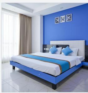a blue bedroom with a large bed with blue walls at Hotel Season Couple friendly Rooms Best Hotel Pitampura metro station in New Delhi
