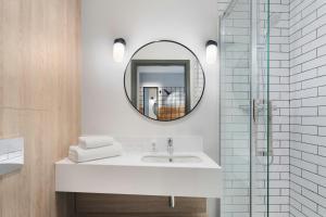 a bathroom with a sink and a mirror at Moxy Belfast City in Belfast +31 photos