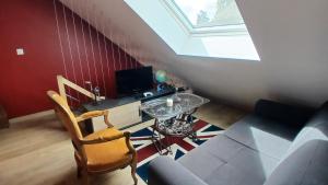 a living room with a couch and a glass table at la bicyclette rouge by les étapes chartraines in Chartres