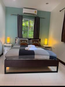 a bedroom with a bed with two towels on it at Private Luxury Poolvilla, Koh Chang in Ban Dan Mai +29 photos