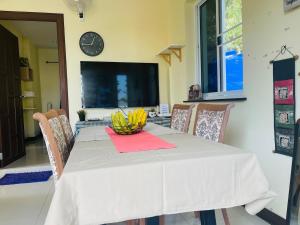 a dining room table with a bowl of bananas on it at Private Pool Villa , 4BR, Fast WiFi, BBQ Garden in Ban Dan Mai +28 photos