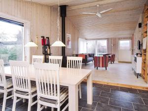 a dining room and living room with a table and chairs at 6 person holiday home in Slagelse in Slagelse