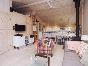 a living room with a couch and a tv at 6 person holiday home in Slagelse in Slagelse
