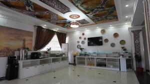 a room with white shelves and a ceiling with paintings at Hotel Khiva Palace in Khiva