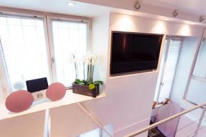 a living room with a flat screen tv on a wall at Stylish,luxury duplex Paris city center in Paris