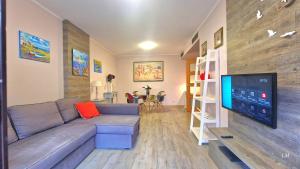 a living room with a couch and a flat screen tv at Apartment Bonito Go2lloret in Lloret de Mar