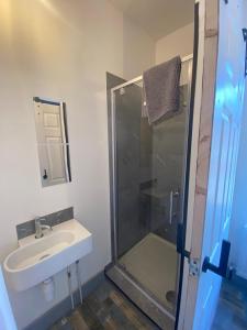 a bathroom with a sink and a glass shower at 2 Newcastle Street in Crewe +31 photos