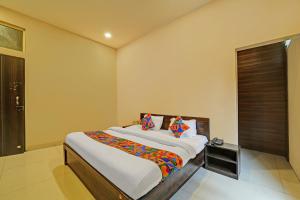 a bedroom with a large bed in a room at FabHotel Grand Stay Ambedkar Nagar in Indore