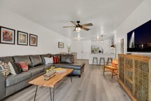 a living room with a couch and a table at Wanderlust #4 | Hot Tub | Shared Outdoor Space in Fredericksburg