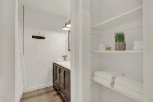 a bathroom with a sink and a counter with towels at Wanderlust #4 | Hot Tub | Shared Outdoor Space in Fredericksburg +22 photos