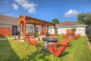 a group of chairs and a grill in a yard at Wanderlust #4 | Hot Tub | Shared Outdoor Space in Fredericksburg
