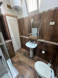 a bathroom with a sink and a mirror at marino casa vacanze in Carini +8 photos