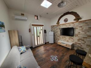 a living room with a couch and a flat screen tv at marino casa vacanze in Carini