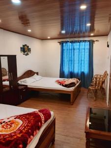 a room with two beds and a window at Mountain Paradise Homestay BATASIA LOOP in Darjeeling