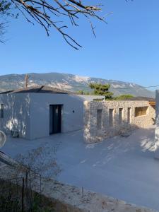 a large white building with a door on the side at Profil villas in Spartià