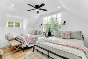 a bedroom with two beds and a ceiling fan at Luxury Combo Walk to Main with 2 Hot-Tubs in Fredericksburg