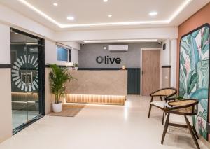 a lobby with a live sign on the wall at Olive Hotel Millers Road by Embassy Group in Bengaluru