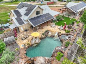 an aerial view of a house with a swimming pool at West End Luxury Retreat with Resort Style Pool and Hot Tub! in Fredericksburg
