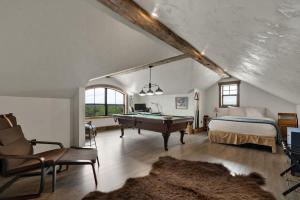 a bedroom with a bed and a pool table at West End Luxury Retreat with Resort Style Pool and Hot Tub! in Fredericksburg +25 photos