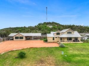 an aerial view of a house with a yard at West End Luxury Retreat with Resort Style Pool and Hot Tub! in Fredericksburg