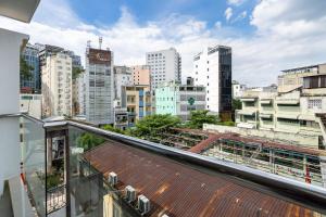a view of a city from the balcony of a building at Ekomo Home 95 - Metro Ben Thanh in Ho Chi Minh City