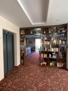 a room with a library with bookshelves at Hotel Aristokrat in Obzor