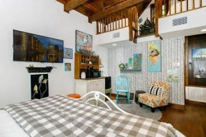 a bedroom with a bed and a living room at Remmler Nest Hot-Tub Prime Location 3-Blks to Main! in Fredericksburg