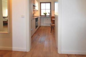 a hallway with a kitchen and a dining room at Aesten Mare Kühlungsborn Apartment 2 in Kühlungsborn