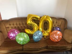 a bunch of balloons on a couch with a number at Hotel Aristokrat in Obzor