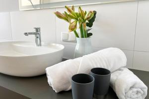 a bathroom with a sink and a toilet and a sink at Aesten Mare Kühlungsborn Apartment 2 in Kühlungsborn