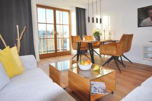 a living room with a couch and a table at Aesten Mare Kühlungsborn Apartment 2 in Kühlungsborn