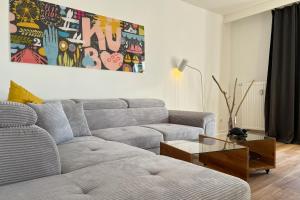 a living room with a couch and a table at Aesten Mare Kühlungsborn Apartment 2 in Kühlungsborn +17 photos