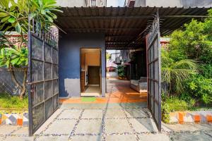 an open door to a house with a blue wall at Super Hotel O Hingna Road Near Rachana Metro Station in Nagpur