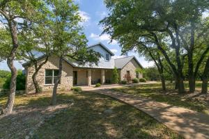a stone house with a driveway at Spicewood Lodge w/Pool, HotTub in Spicewood
