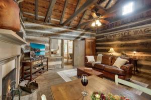 a living room with a couch and a table at Town Creek Cabin Walk to Main St in Fredericksburg
