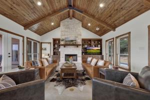 a living room with couches and a fireplace at Luxury in the Hill Country, 10-Mins to Downtown! in Fredericksburg