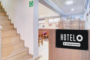 a restaurant with a hotel sign next to a staircase at Hotel O Hari Singh High Street Formerly City Star in Jawāharnagar +37 photos